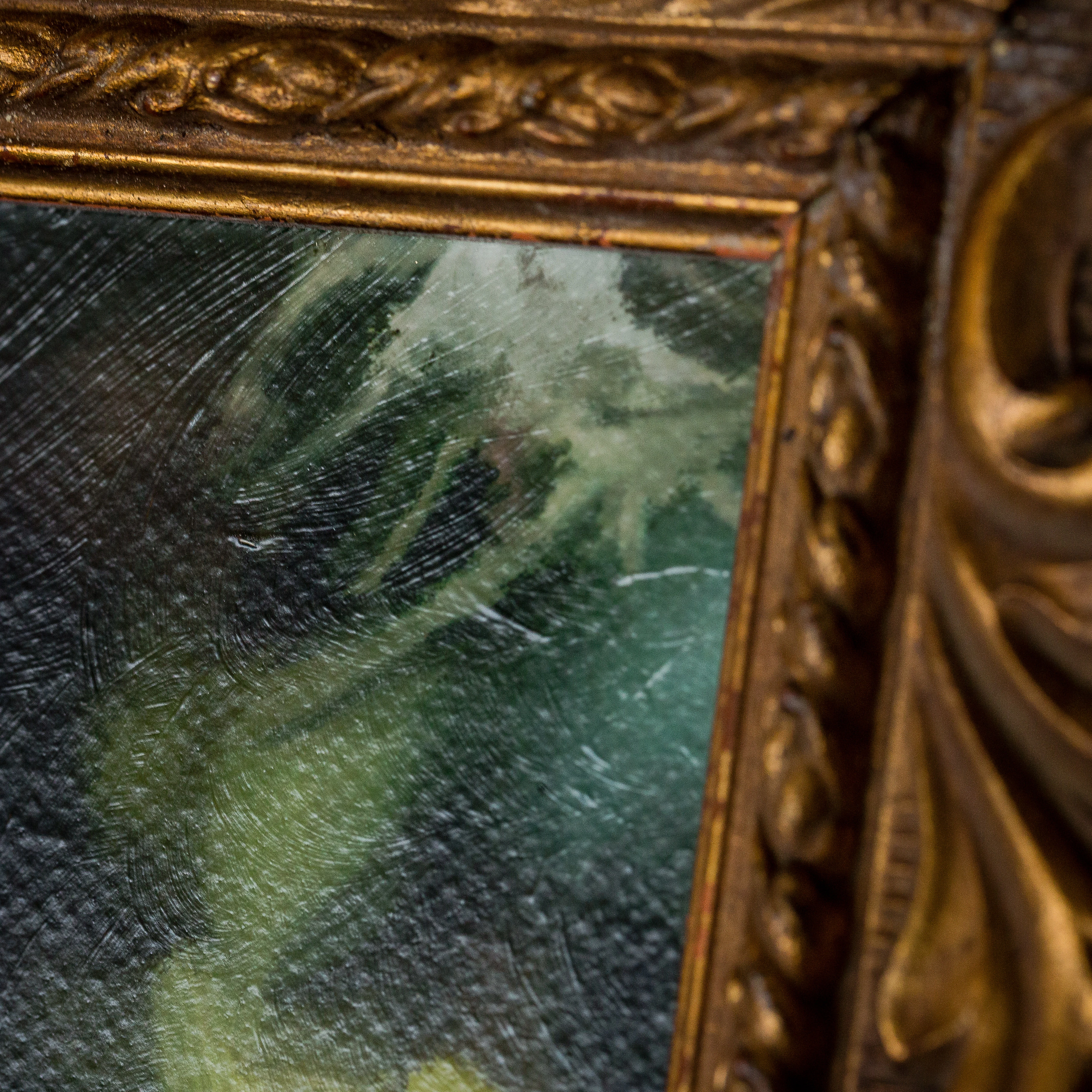 Close-up of fine art portrait showing brushstroke texture and ornate gilded frame detail