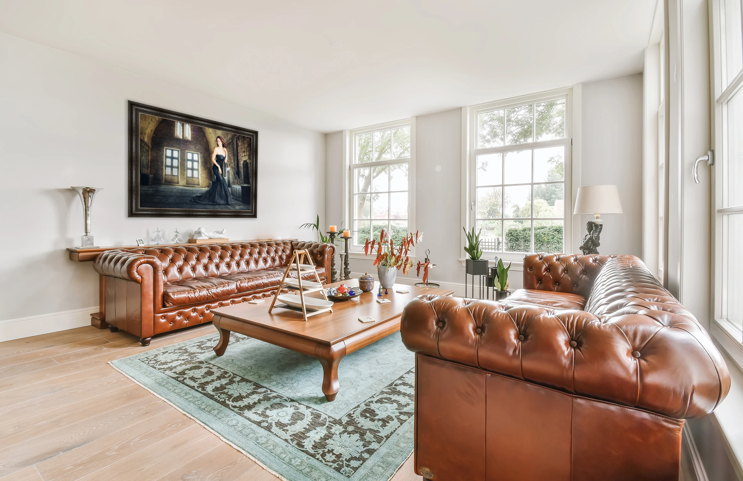 Artwork displayed in a luxury living room above a leather sofa
