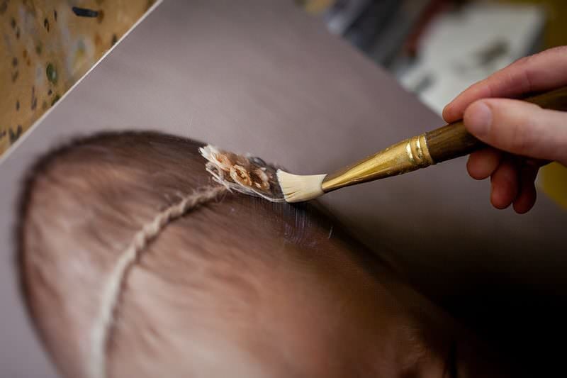 Close-up detail showing brushstroke texture of hand-finished artwork
